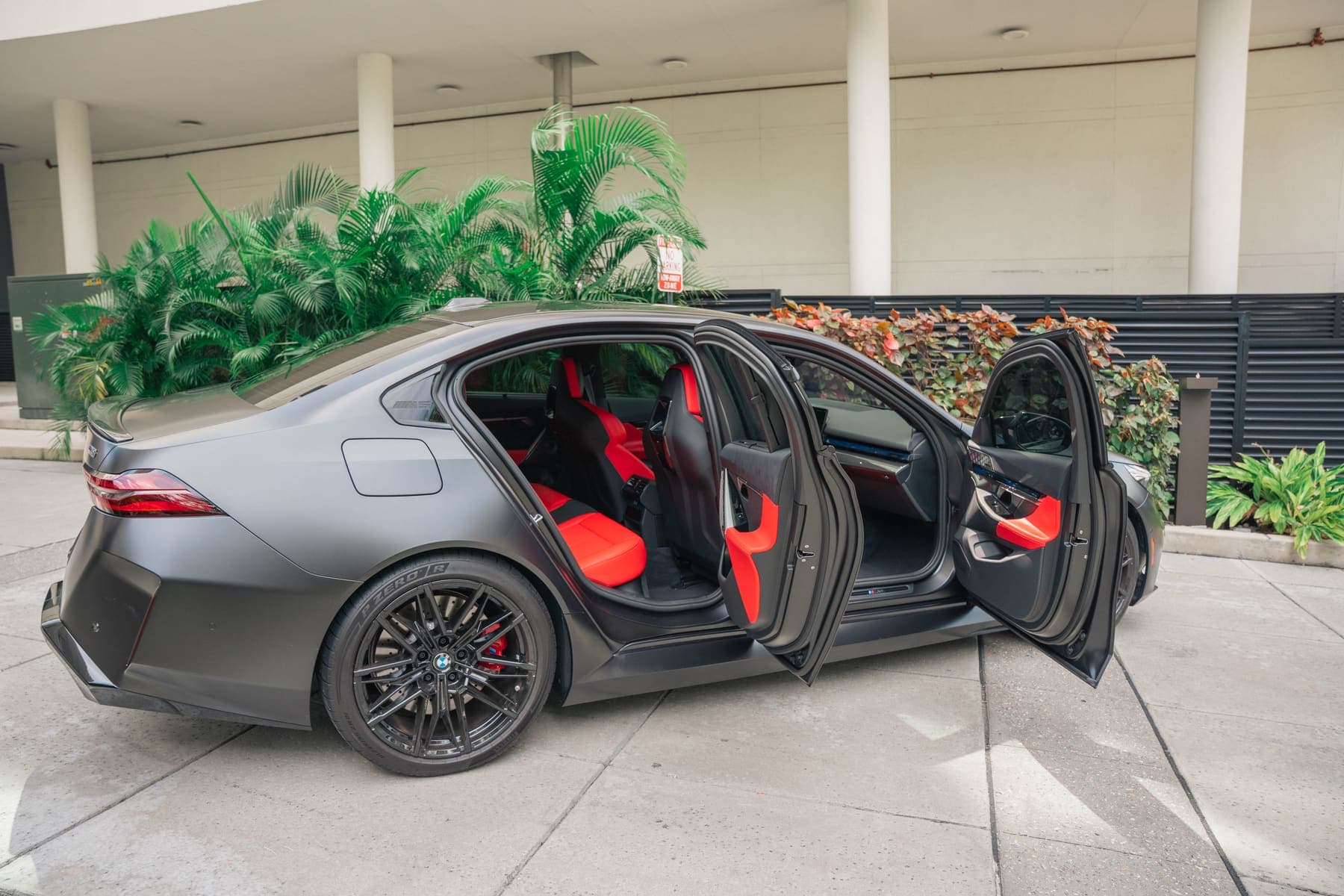 BMW M5 with doors open after a full interior and exterior detail